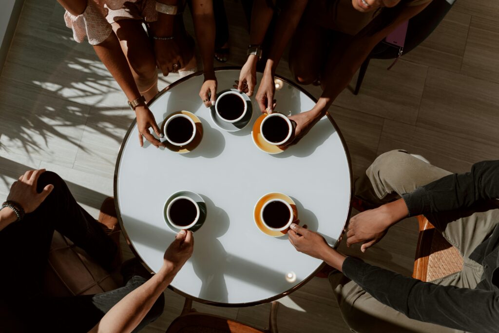 white circle table with 5 mugs of coffee sitting on it